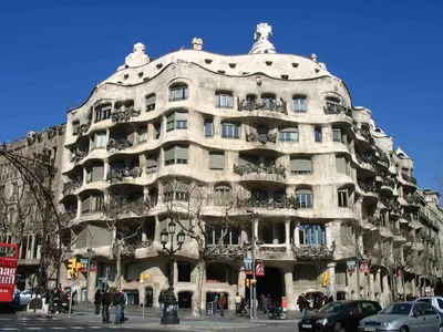 a large white building with people standing in front of it at Mirall Sant Gervasi in Barcelona