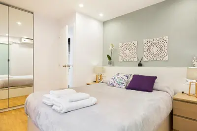 a bedroom with a bed with towels on it at Apartamento Rambla Catalunya in Barcelona