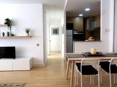 a kitchen and dining room with a table and chairs at Apartments BCN Central-Montjuic in Barcelona