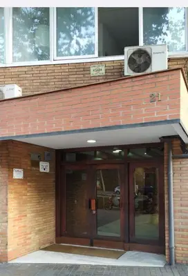 an entrance to a building with a large glass door at Apartments BCN Central-Montjuic in Barcelona