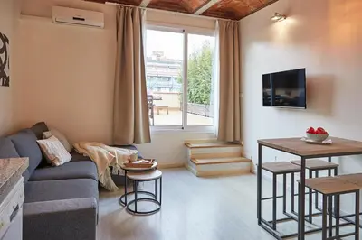 a living room with a couch and a tv at BBarcelona Sagrada Familia Flats in Barcelona