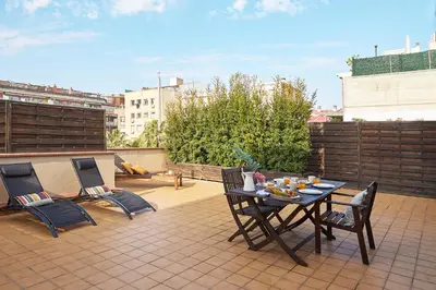 a patio with a table and chairs on a roof at BBarcelona Sagrada Familia Flats in Barcelona