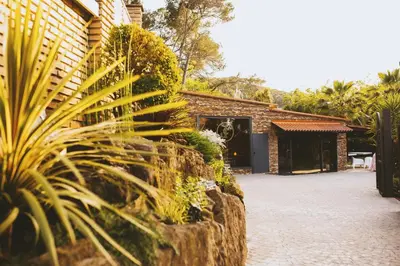 a table and chairs in a garden with plants at CARIBBEAN Home in Montcada i Reixac