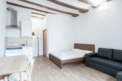 a living room with a couch and a table at Homenfun Barcelona Studio Camp Nou II in Hospitalet de Llobregat