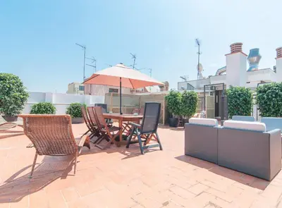 a patio with a table and chairs and an umbrella at Picasso Suites in Barcelona