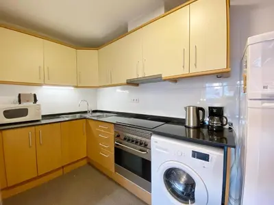 a kitchen with a washer and a dishwasher at Terracotta terrace in Barcelona