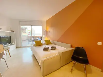 a bedroom with a bed and a chair in it at Terracotta terrace in Barcelona