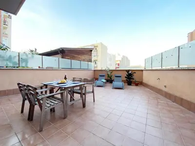 a balcony with a table and chairs on a building at Terracotta terrace in Barcelona