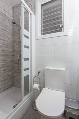 a white bathroom with a toilet and a shower at Bright 3bdr Near To The Metro in Hospitalet de Llobregat