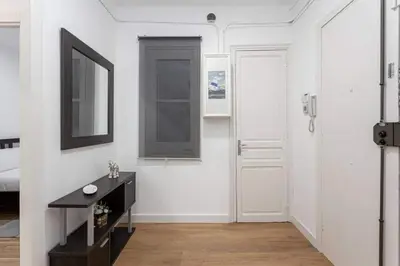 a white room with a black desk and a window at Bright 3bdr Near To The Metro in Hospitalet de Llobregat