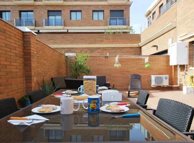 a table with plates of food on a patio at Home Pool and Beach in Cabrera de Mar