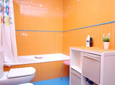 an orange bathroom with a tub and a toilet and a sink at Home Pool and Beach in Cabrera de Mar