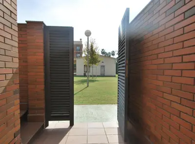 a brick wall with a door leading into a courtyard at Home Pool and Beach in Cabrera de Mar
