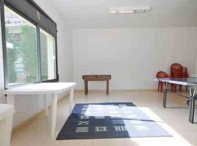 a room with a window and a table and a rug at Home Pool and Beach in Cabrera de Mar