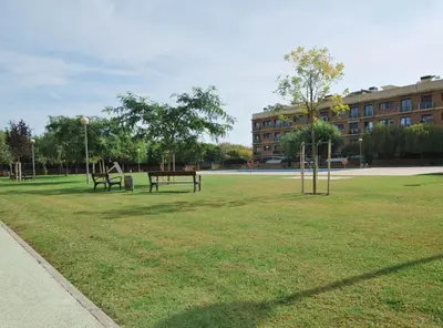 a park with two benches and a playground at Home Pool and Beach in Cabrera de Mar
