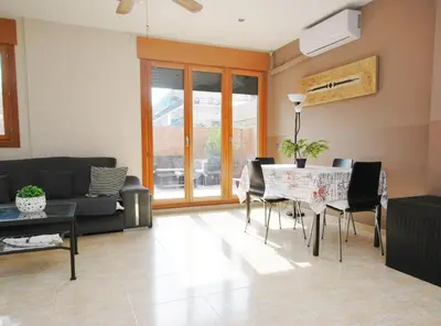 a living room with a table and chairs at Home Pool and Beach in Cabrera de Mar