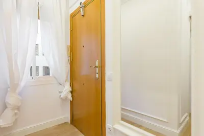 a wooden door in a room with a window at Moreryadom in Barcelona