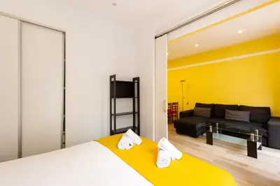 a bedroom with a bed and a couch in a room at Stay U-nique Apartments Lope de Vega in Barcelona