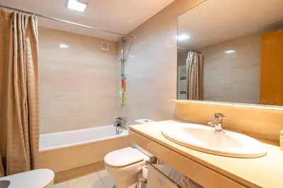a bathroom with a sink and a toilet and a tub at Stay U-nique Apartments Diagonal II in Barcelona