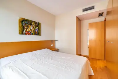 a bedroom with a bed and a painting on the wall at Stay U-nique Apartments Diagonal II in Barcelona