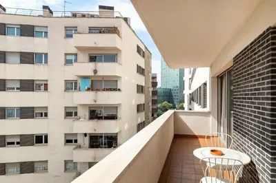 a balcony with a view of a tall building at Stay U-nique Apartments Diagonal II in Barcelona