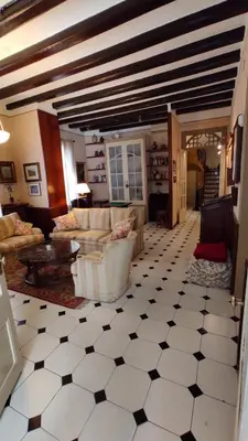a large living room with a black and white tiled floor at Casa MO in Sabadell