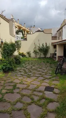 a stone path in a yard with a bike parked on it at Casa MO in Sabadell