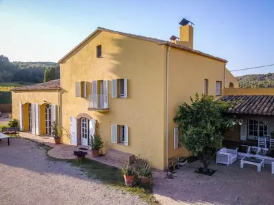 a yellow house with a table and chairs in front of it at Lidia's Rural House (HUTB-0615) in Barcelona