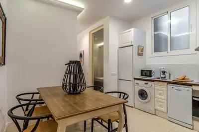 a kitchen with a table and chairs in a room at AB Eixample Calabria in Barcelona