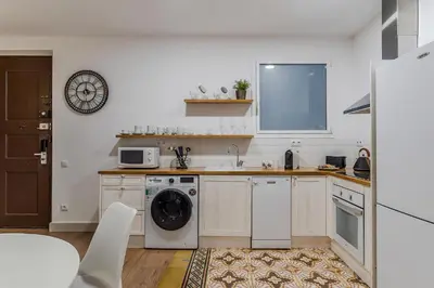a kitchen with a washing machine and a washer at AB Eixample Calabria in Barcelona
