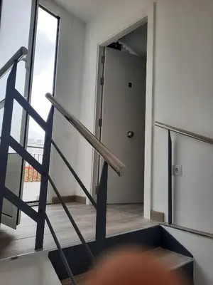 a staircase in a room with a door and a stair case at Apartaco Apartamentos in Sitges