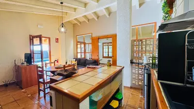 a kitchen and living room with a counter top at Apartment with private pool and garden in San Martín Sarroca