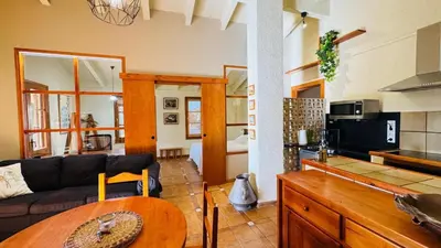 a living room with a couch and a table at Apartment with private pool and garden in San Martín Sarroca