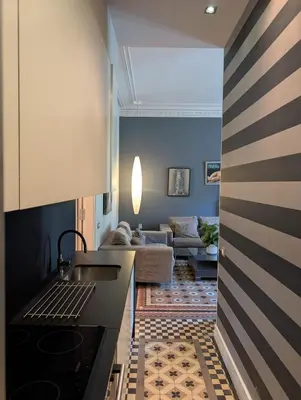 a kitchen with a stove and a living room at Period Luxury Apartment in Barcelona Prime Location with Street View in Barcelona