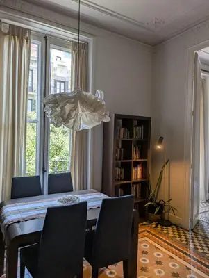 a dining room with a table and chairs and a chandelier at Period Luxury Apartment in Barcelona Prime Location with Street View in Barcelona