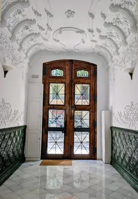 a room with a large wooden door in a building at Period Luxury Apartment in Barcelona Prime Location with Street View in Barcelona