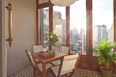 a dining room with a table and chairs and a window at My Space Barcelona Rambla Catalunya Center in Barcelona