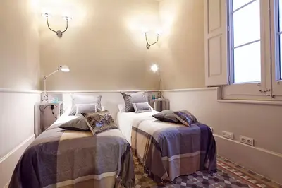 a bedroom with two beds with blankets and a window at My Space Barcelona Rambla Catalunya Center in Barcelona