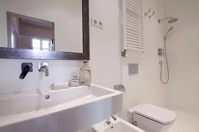a white bathroom with a sink and a toilet at My Space Barcelona Rambla Catalunya Center in Barcelona