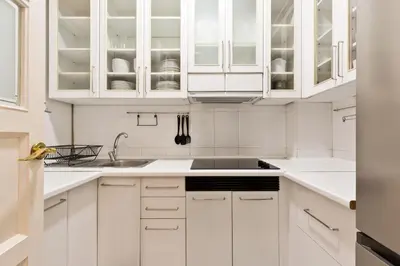 a white kitchen with white cabinets and a sink at Stay U-nique Apartments Consell in Barcelona