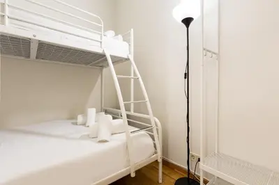 a white bunk bed in a room with a lamp at Stay U-nique Apartments Consell in Barcelona