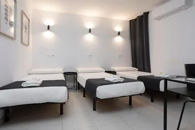 a hospital room with four beds and a desk at HOSTAL BEDMATES in Barcelona
