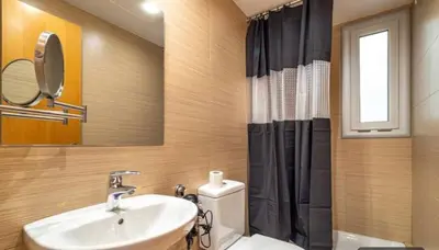 a bathroom with a sink and a toilet and a mirror at HOSTAL BEDMATES in Barcelona