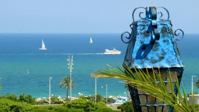 a statue with a view of the ocean and sailboats at Stay U-nique Apartments Taulat in Barcelona
