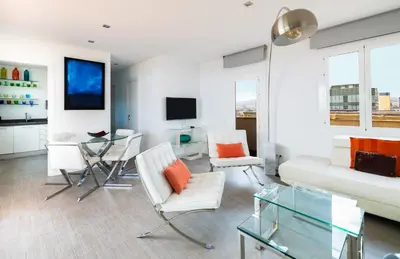 a living room with white furniture and a tv at Stay U-nique Apartments Taulat in Barcelona