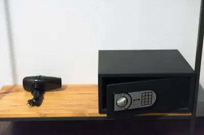 a black microwave sitting on a shelf with a pen at Traveller House in Barcelona