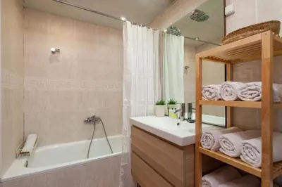 a bathroom with a tub and a sink and a shower at Flateli Paris in Barcelona