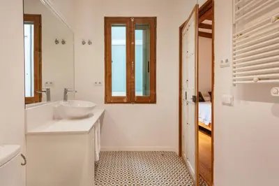 a white bathroom with a sink and a tub at Bellafila Gothic Terrace in Barcelona