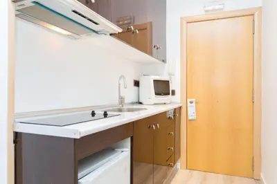 a small kitchen with a sink and a microwave at Cathedral Apartments in Barcelona