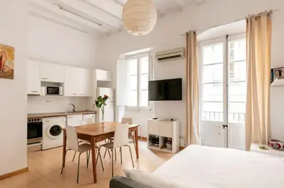a kitchen and dining room with a table and chairs at BELLAFILA GOTHIC in Barcelona